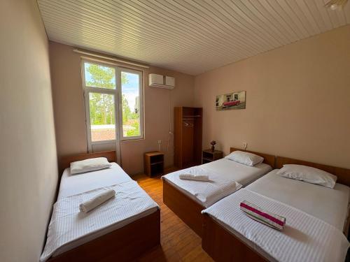 a room with two beds and a window at hotel shomari in Grigoleti
