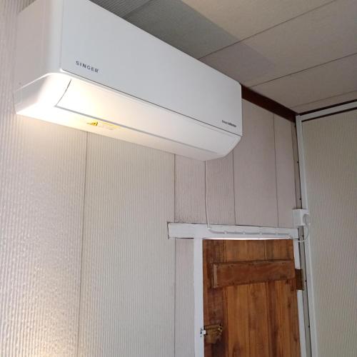 a white overhead light in a room with a door at Salt Bay Kite and Dive Resort in Kalpitiya