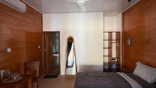 a bedroom with a bed and a table in a room at The Tree Poolbar&Resort in Gili Islands
