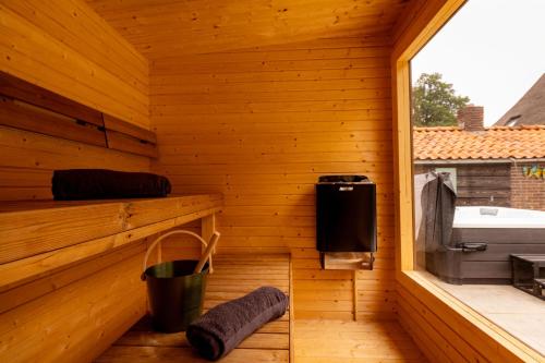 aoutside view of a wooden sauna with a window at De Boerstee in Ruinerwold