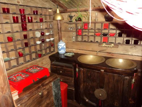 a bathroom with a sink in a room at Le Nid Du Dragon Rouge in Courniou
