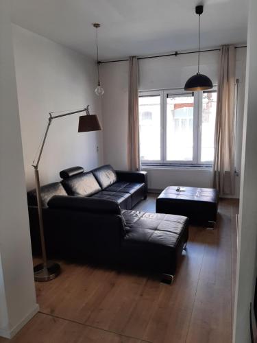 a living room with a couch and a table at APP Amsterdamstr glv in Ostend