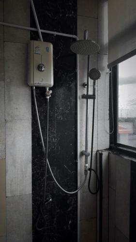 a shower in a bathroom with a shower at the loft residence in Ban Plai Khlong Bang Noi