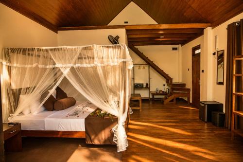 a bedroom with a bed with a canopy at Sunrise Mount View in Ella