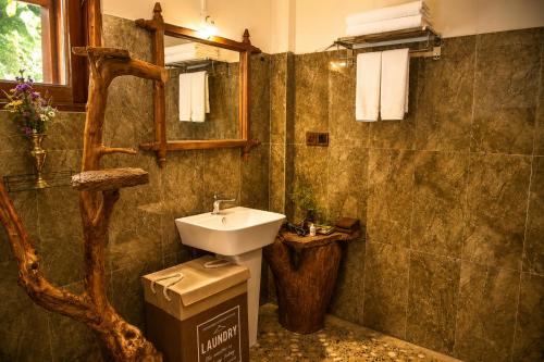 a bathroom with a sink and a toilet and a mirror at Sunrise Mount View in Ella