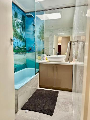 a bathroom with a sink and a shower and a tub at Jalynn homestay in Glen Waverley