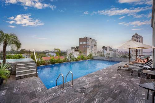 a swimming pool on the roof of a building at Le Jardin Hotel Haute Couture in Hanoi