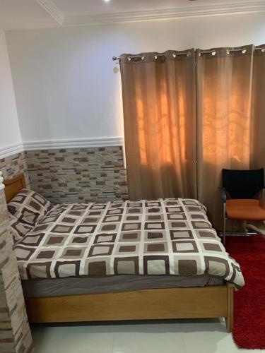 a bedroom with a bed in a room at FREDJACKSAIR BNb in Koforidua