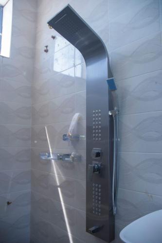 a shower in a bathroom with a glass door at Wete View Hotel in Wete