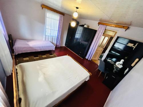 a small room with a bed and a tv at Davitis Vila in Chakvi