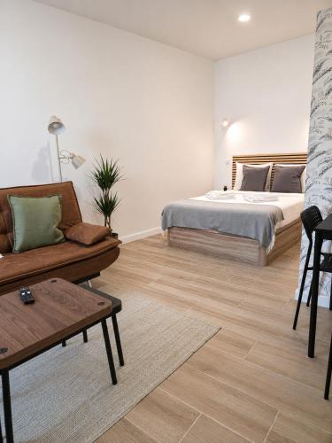 a living room with a bed and a couch at Casa Nº9 - Vila d'Óbidos in Óbidos