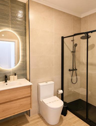 a bathroom with a toilet and a sink and a shower at Casa Nº9 - Vila d'Óbidos in Óbidos
