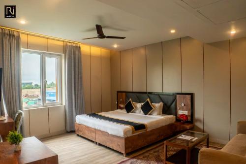 a bedroom with a bed and a large window at Hotel Runway Inn in Pura Raghunāth