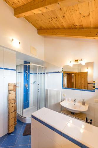 a bathroom with a sink and a shower at Schmiedlehnerhof in Birnberg