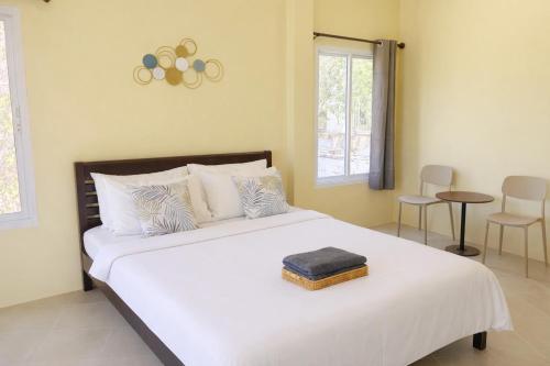 a bedroom with a large white bed with white pillows at Koniix Garden Cottage Ko Sichang in Ko Si Chang