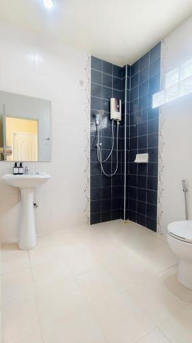 a bathroom with a shower and a sink and a toilet at Koniix Garden Cottage Ko Sichang in Ko Si Chang