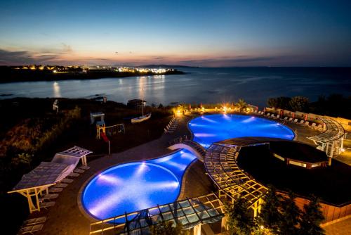 a view of a swimming pool at night at Arapya Sun Resort in Arapya