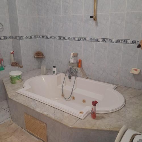 a bath tub with a faucet in a bathroom at Rejiche in Rejiche
