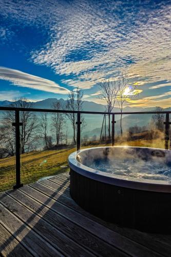 a jacuzzi tub on a deck with a view at ZakoGlamp Glamping Pod Gubałówką z Jacuzzi in Ząb
