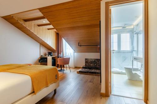 a bedroom with a bed and a fireplace at Ouro Rossio Hotel in Lisbon