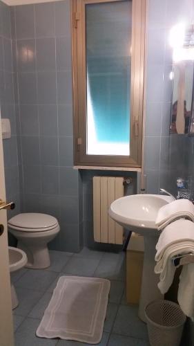 a bathroom with a sink and a toilet and a window at Residence la Vignetta in Varazze