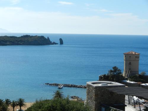 a view of a body of water with a lighthouse at Villa Giglio Rosso in Campese