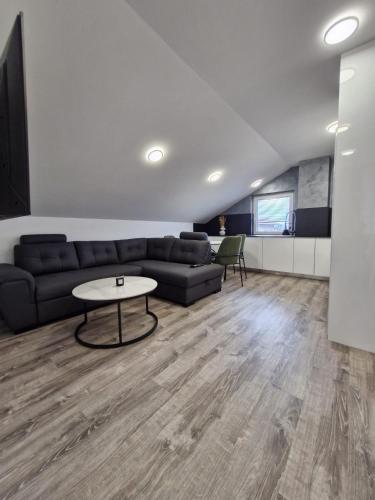 a living room with a couch and a table at Livada in Ljubljana