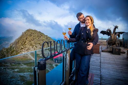 a man and a woman holding glasses of wine at Noc na Chopku, Rotunda in Belá