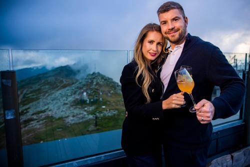 a man and a woman holding a glass of wine at Noc na Chopku, Rotunda in Belá