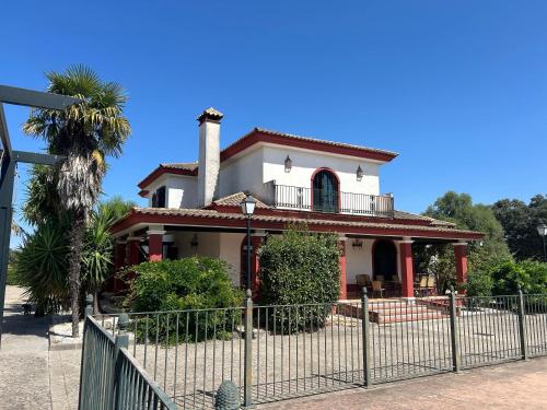 a house with a fence in front of it at Finca Los Majadales in Almodóvar del Río