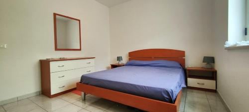 a bedroom with a bed and a dresser and a mirror at Gioia Casa in Pizzo