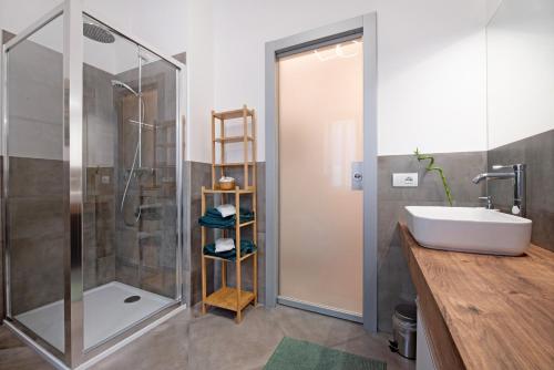 a bathroom with a sink and a shower at Maddy's House in Mandello del Lario