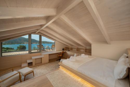 a bedroom with a large bed and a large window at Villa Carina by TwentyTwo in Ancient Epidauros