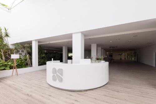a large white building with a table with scissors on it at BLUESEA Costa Jardin & Spa in Puerto de la Cruz