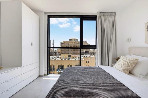 a bedroom with a bed and a large window at  