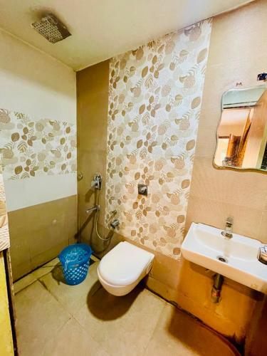 a bathroom with a toilet and a sink at Meridian Residency in Ernakulam