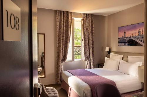 a hotel room with a bed and a window at Hôtel Le Relais Saint Charles in Paris