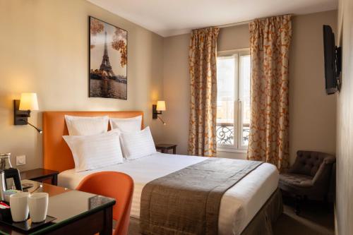 a hotel room with a bed and a window at Hôtel Le Relais Saint Charles in Paris