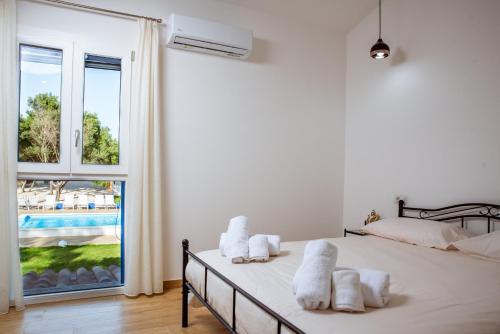 a bedroom with a bed and a large window at Villa Rose Sardegna in Calasetta