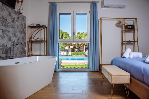 a bathroom with a tub and a bed and a window at Villa Rose Sardegna in Calasetta