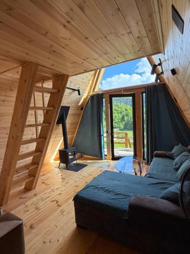 a room with a bed and a large window at Larda in Nankvam-Zagrali