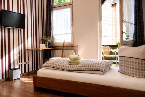 a bedroom with a bed with two towels on it at Gästehaus Elisabeth in Schlangenbad