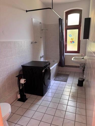 a bathroom with a tub and a sink and a shower at Emmerstedt - Alte Schule in Helmstedt