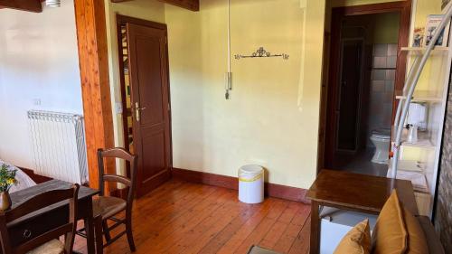 a living room with a toilet and a wooden floor at B&B Muggianeddu in Tonara