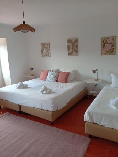 a bedroom with two beds and two tables at Casa do Rio By Viva a Vida - Alojamentos & Hotels in Constância