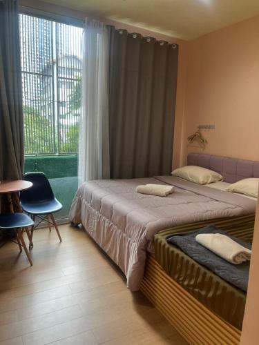 a hotel room with two beds and a window at Sleep cafe hidee247 in Pratunam