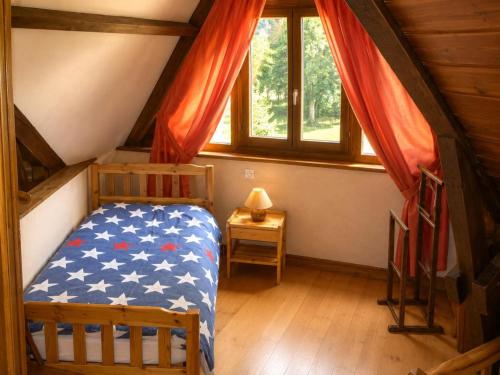 a bedroom with a bed with an american flag blanket at Le coin de paradis in Bouvellemont