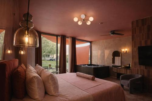 a bedroom with a large bed and a bathroom at heart & ponie - Retiro Rural Privado con Piscinas in Chinchón
