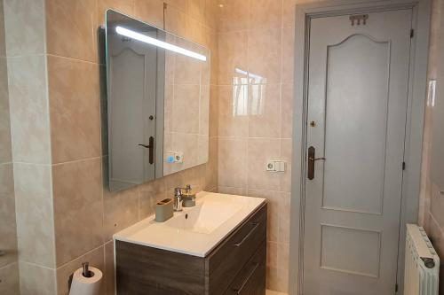 a bathroom with a sink and a mirror at Opening Doors Premiá Dalt Amazing views w pool in Premia de Dalt