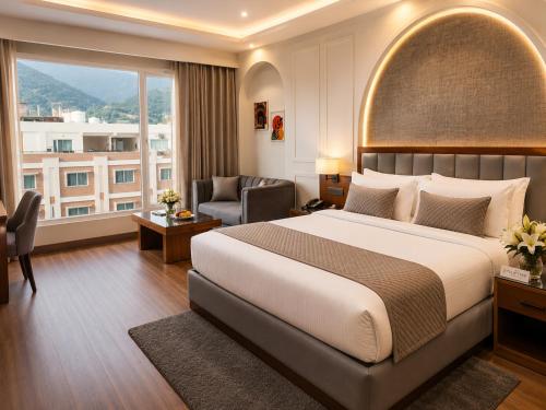 a hotel room with a large bed and a window at Tulip Tree Hotel in Katra
